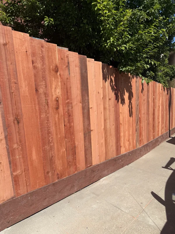 Vertical wood boards create a clean, continuous fence line.